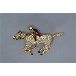 18K YELLOW GOLD BROOCH, realistically formed as a horse and jockey, encrusted with approximately...
