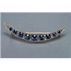 Image 1 : 9K YELLOW GOLD AND SILVER CRESCENT BROOCH, set with a double graduated row of 9 oval cut sapphire...