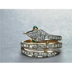 18K YELLOW GOLD RING, formed as a serpent and set with 49 brilliant cut diamonds (approx. 0.62ct....