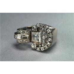 14K AND 18K WHITE GOLD FILIGREE RING, asymetrically set with an emerald cut, 3 baguette cut, 2 br...