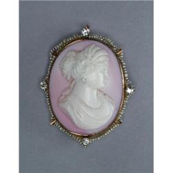 OVAL CARVED PINK SHELL CAMEO, depicting a classical maiden, in a 10k yellow gold brooch/pendant m...