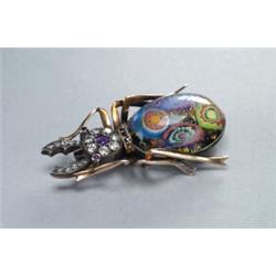 14K YELLOW GOLD AND SILVER BROOCH, realistically formed as a beetle set with 17 various round cut...