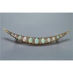 10K YELLOW GOLD CRESCENT BROOCH, set with 11 oval opal cabochons alternating with 32 various old...