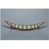Image 1 : 10K YELLOW GOLD CRESCENT BROOCH, set with 11 oval opal cabochons alternating with 32 various old...