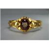 Image 1 : 14K YELLOW GOLD HINGED BANGLE, with a central medallion bezel set with an oval garnet cabochon su...