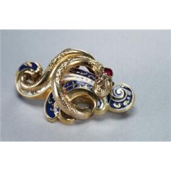 14K YELLOW GOLD BROOCH, formed as a serpent coiled around a fleur-de-lis, set with a red doublet...
