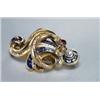 Image 1 : 14K YELLOW GOLD BROOCH, formed as a serpent coiled around a fleur-de-lis, set with a red doublet...