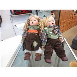2 Collectible porcelain dolls on a bench