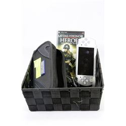 PSP WITH THREE GAMES, CHARGER AND CASE