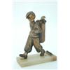 A Lorenzl spelter table lighter, modelled as a golfer, carrying a golfing bag, on a green onyx ba...