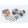 A Schuco tinplate clockwork 1930s Mercedes racing car, no. 1050, including associated spare parts...