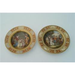 A pair of Vienna cabinet plates, of circular shape, the central panels painted with figures, one...