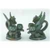 Image 1 : A pair of C H Brannam chambersticks, modelled as griffins, their tails fashioned as handles, on o...