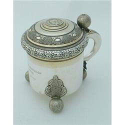 A 1930's Swedish white metal "peg" tankard, with ball finial, strapwork and foliate banding, scro...
