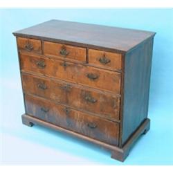 An early 18th century walnut chest, having moulded top over three short and three graduated long...