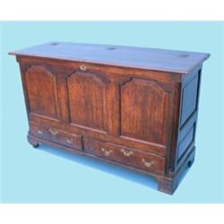 A George III oak mule chest, having moulded planked top over mahogany cross-banded and inlaid tri...