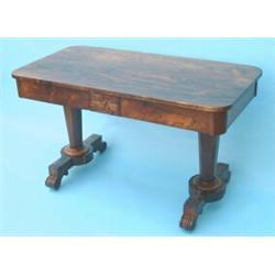 An early Victorian rosewood library table, having carved frieze fitted two drawers on tapered oct...