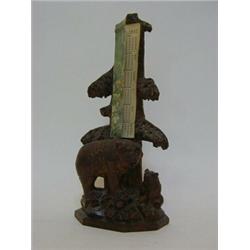 A BLACK FOREST STYLE DESK CALENDAR, carved bear and cub below a fir tree with cardboard insert da...