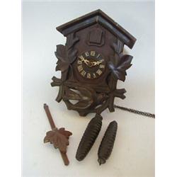 A CUCKOO CLOCK, 20th Century, (pendulum and two pine cone weights)  30-40...