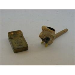 A BRASS POCKET TINDER BOX, dated '1797' and an erotic clay pipe bowl (2)  20-30...