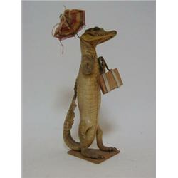 A NOVELTY BABY CROCODILE FIGURE, formed as a lady with handbag and parasol taking a stroll, heigh...
