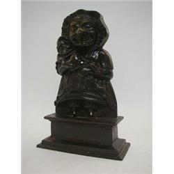A CAST IRON DOOR STOP, early 20th Century, formed as Judy holding Mr Punch, height 34cm  30-40...