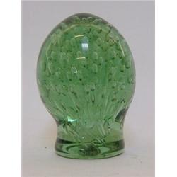 A GREEN GLASS DUMPY DOOR STOP, bubble inclusions, pontil base, height 18cm  50-80...