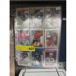 27 Autographed sports trading cards in binder