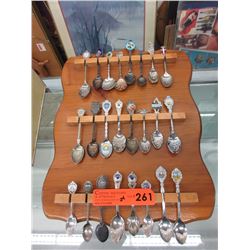 24 Collector spoons on wall plaque