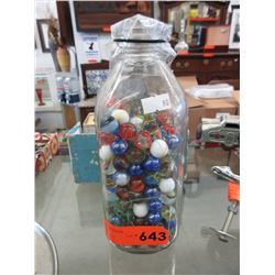 Glass milk bottle containing glass marbles