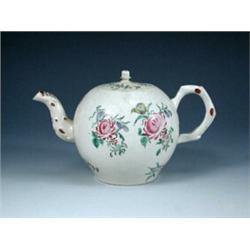 A mid 18th century saltglaze teapot and cover, the latter pierced through the acorn knop, the spher.