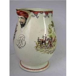 A Leeds Pottery creamware mask jug printed and overpainted with Masonic arms on one side and a hunt.