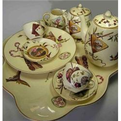 A late 19th century Powell, Bishop and Stonier cabaret set, each piece printed and overpainted with.