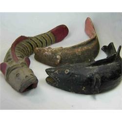 Three primitively potted fish models, each curved, one striped with red fins, one terracotta and th.