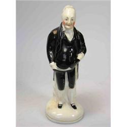 A mid 19th century figure of Dr Syntax, the rubicund old gentleman standing wearing a black suit, 1.