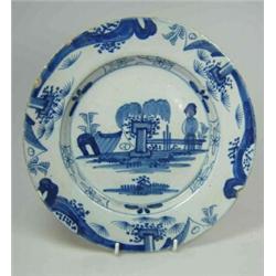 A mid 18th century Delft blue and white plate painted with a Chinese figure and a pavilion flanking.