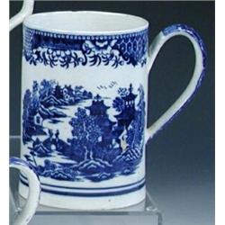 A late 18th century blue and white pearlware mug, possibly Caughley, the cylindrical sides printed..