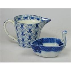 An early 19th century blue and white butter boat printed with berries and diaper rim band, 7cm wide.