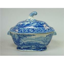 An early 19th century blue and white sauce tureen and cover printed with travellers by a lake in fr.