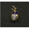 Image 1 : A small gold pendant of ribbed ovoid form set with two sapphires and three diamonds as a flower, 30.