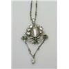 Image 1 : A silver pendant with pearl centre within a wreath of leaves above three small emeralds, the drop w.