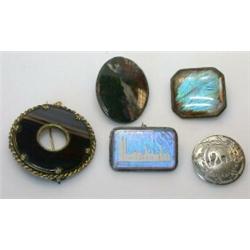 A group of five decorative brooches including: two small butterfly wing brooches (one depicting the.