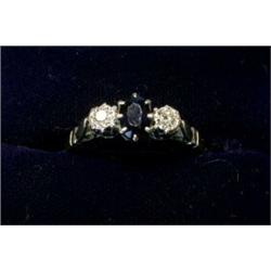 An 18ct gold ring with sapphire and two diamonds  £90-120...