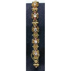 A 9ct gold gemset articulated bracelet, each link of open scrolls containing three pink and white s.