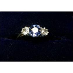 An 18ct gold ring with platinum setting with a sapphire and two diamonds  £230-260...
