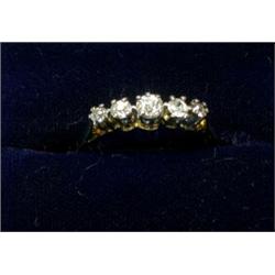 An 18ct gold ring with platinum setting containing five graduated diamonds  £80-120...