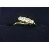 Image 1 : An 18ct gold ring with platinum crossover setting containing four diamonds  £70-100...