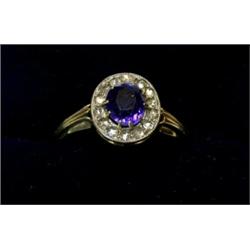 An oval ring with sapphire within a surround of rosecut diamonds  £100-150...