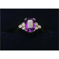 An 18ct gold ring set with an amethyst each shoulder set with three small diamonds  £130-150...