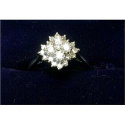 An 18ct white gold ring set with a rectangular cluster of modern brilliant cut diamonds £200-250...